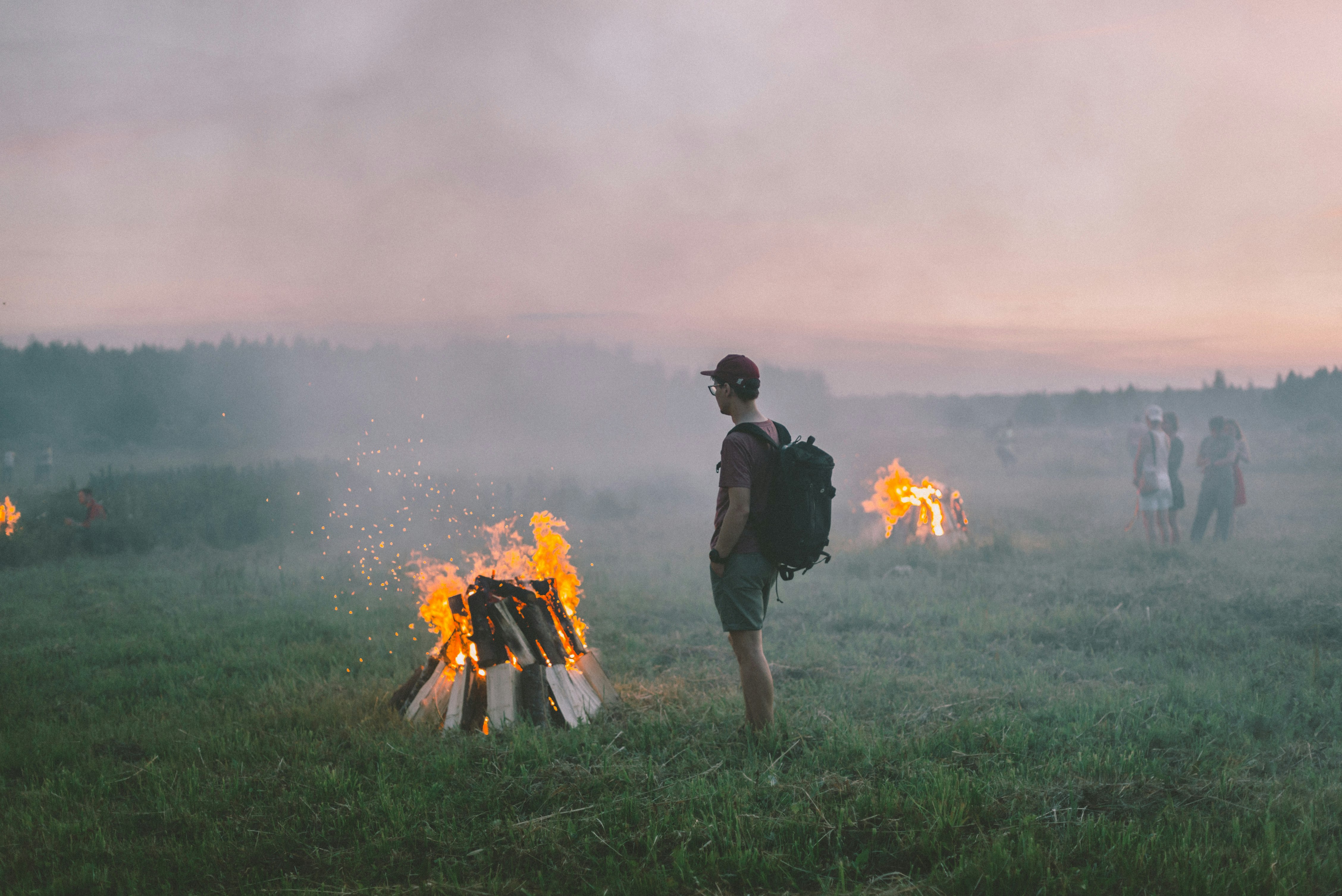 man standing near flame